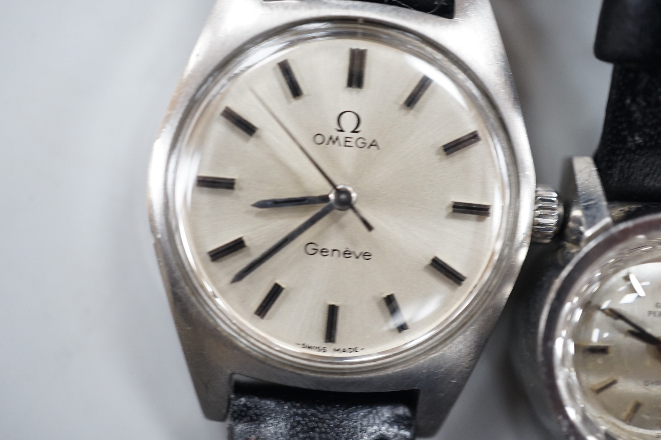 A lady's stainless steel Omega manual wind wrist watch, with baton numerals, together with a lady's stainless steel Zenith square dial manual wind wrist watch and a similar Girard Perregaux manual wind wrist watch.